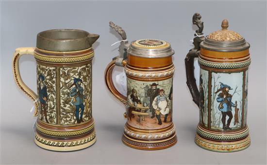 A Mettlach stein decorated with a huntsman, a similar jug and another with topers tallest 24cm